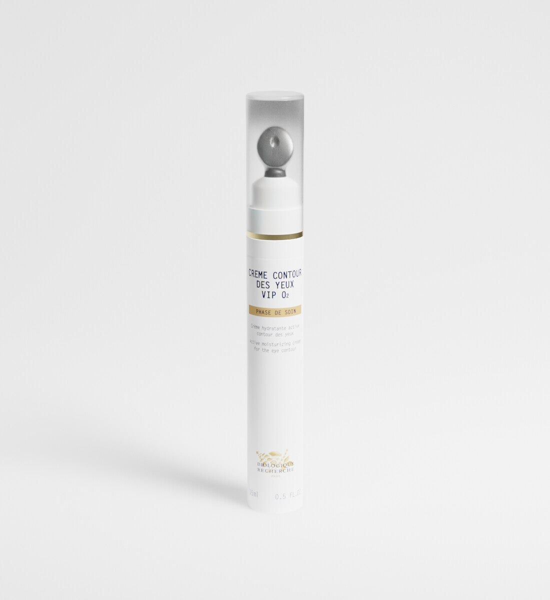 Skincare bottle with gold accents on a white background